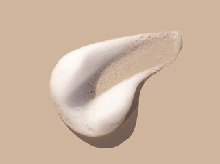 texture foam mousse foam cosmetic smear sample on beige background