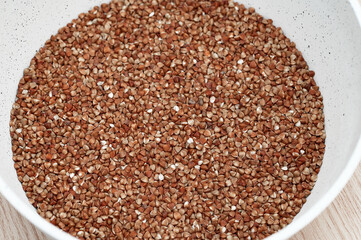 Surowe ziarna kaszy gryczanej w garnku, tło wzór deseń 