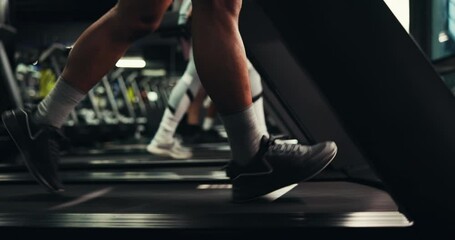 Sneakers, legs and person on treadmill in gym, exercise and wellness with endurance training with equipment at night. Cardio, machine or late workout with energy, running footwear or steps for health