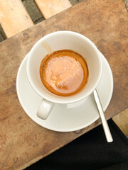 Fresh Espresso Shot in White Cup on Rustic Table