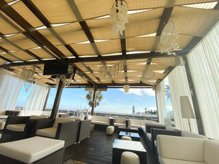 Coastal Lounge Terrace with Modern Seating and Lighthouse Vie