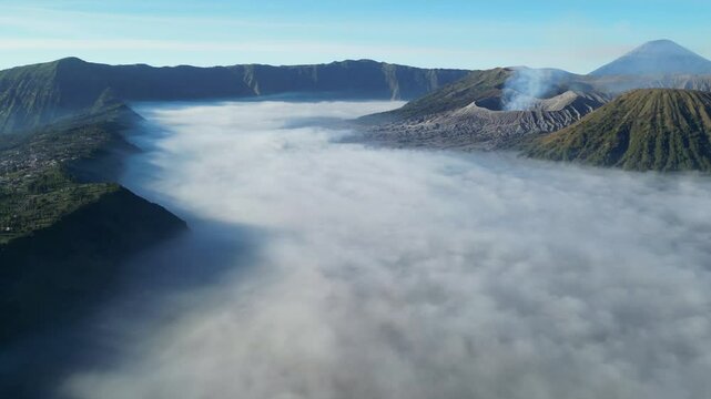Bromo and Semeru volcano on plateau covered with fog. Sunrise on Java island.
