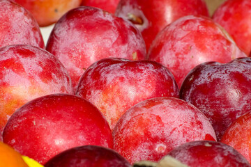 fresh plums on a market stall 
