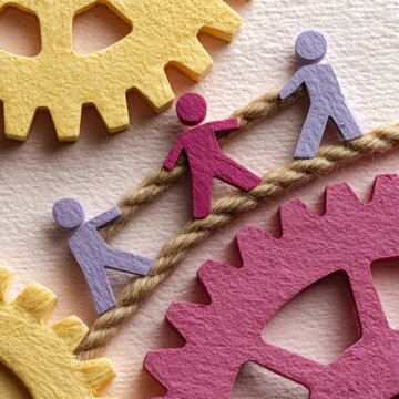 Teamwork illustration with paper figures and gears