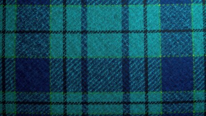 High-resolution close-up detailed image showing the texture of a teal and navy blue plaid fabric with subtle variations in the weave