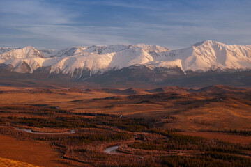 Majestic Altai mountains overlooking serene Siberian landscape at sunset