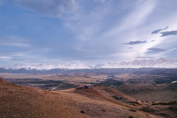 Scenic mountain vista with river and car with camper trailer trip in Altai Siberia Russia