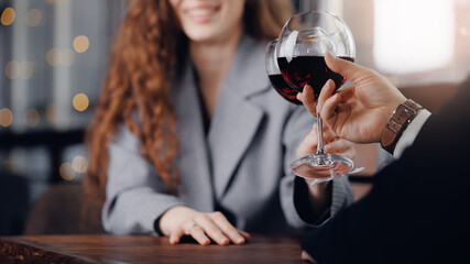 Romantic date of young caucasian couple enjoying wine at restaurant banner