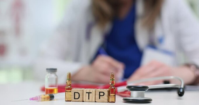 Letters DTP on wooden cubes with vaccine vials and syringe on doctor desk. Lady physician checks test results for diphtheria tetanus and pertussis