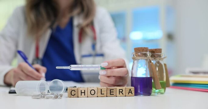 Text Cholera on blocks and pharmacy near doctor with thermometer in clinic. Therapist suggests dangerous diagnosis choosing treatment in hospital