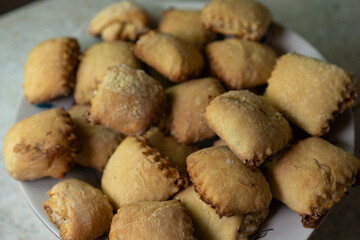 Delicious baked pastries fresh from the oven on a white plate in a cozy kitchen
