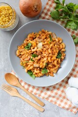 Stir fried macaroni with tomato sauce ,minced pork and egg wi in a grey plate