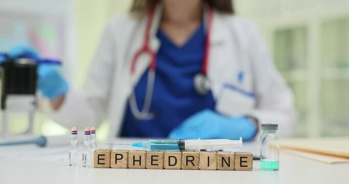 Female professional wearing blue gloves stamps documents working with Ephedrine drug on cubes in clinic office. Pharmaceutical and medical concept