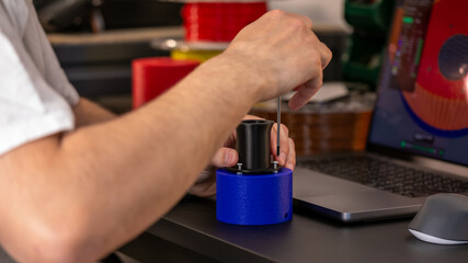 Hispanic male hand delicately assembles futuristic gadgetry, embracing Geek Pride Day's spirit of invention and ingenuity, 3D printer, 3D printing