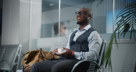 Airport Terminal: Successful Entrepreneur Using Smartphone and Drinking Coffee. African American...