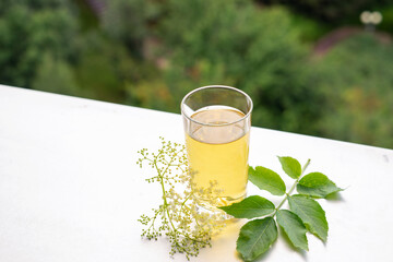 Summer iced elderflower tea on the table
