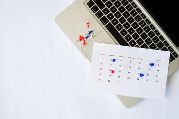 laptop with calendar and pin on the laptop