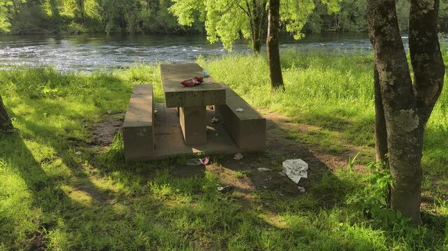 A beautiful but very dirty barbecue area remains after the people have left.