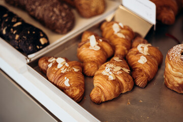 Almond croissants in the bakery, coffee shop, close up.