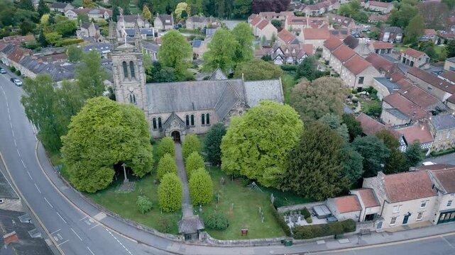 Aerial arc around the old church in central Helmsley. It is very early morning and almost deserted..