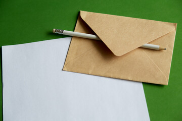 A white pencil on rough paper and an envelope — an association with handwritten ideas and drafts....