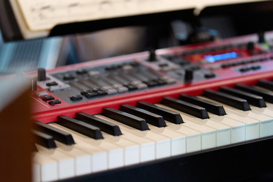 Music: Close-up of a modern red stage piano 