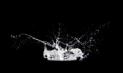 Dynamic Water Splash: A captivating image of water erupting into a dynamic splash, freezing a moment of fluid energy and artistic detail against a dark backdrop. 