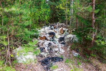 Illegal dump of rubber and polyethylene waste in the forest
