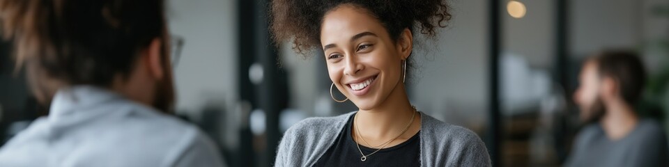 Smiling african female adult engaging in a conversation in office setting