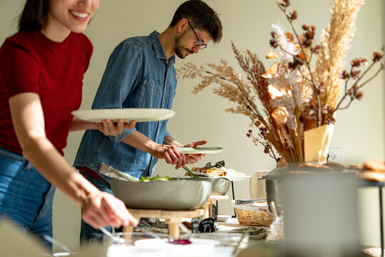 Office workers enjoying healthy food choices at corporate cafeteria buffet, promoting workplace wellness and camaraderie