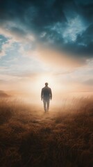 Obraz premium Silhouette of a person walking towards bright light in dramatic landscape