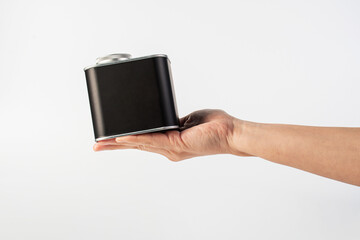 Black can for packaging in hand on white background.