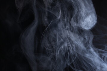 Abstract smoke texture over black background. Fog in the darkness.