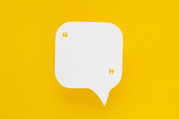 Conceptual image about communication and social media, customer feedback, real blank white speech bubble paper cut, rectangle shape, with quote sign on  yellow color background