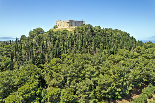Aerial view of medieval Chlemoutsi Castle and coastal village landscape in Peloponnese, Greece, Europe, with sea and forested hills in the background.