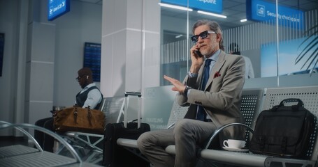 International Airport Terminal: Serious Entrepreneur Irritated About Flight Delay Talking on Phone,...