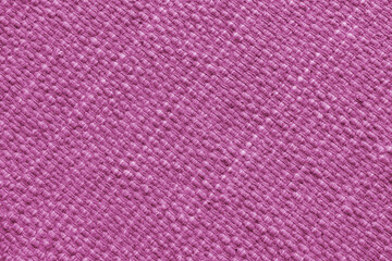 Texture of pink natural fabric with large diagonal weaving. Surface, structure of upholstery or carpet material, cloth background close up.