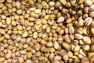 Close-up view of a large pile of shelled pistachios showcasing their unique textures and colors, emphasizing natural food elements and organic appeal