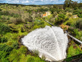 Water sweeping out of the Povoa e Meadas Dam. Natural reserve in Castelo de Vide, Portugal