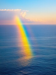 Rainbow over the ocean surface at sunset aerial view nature photography of colorful light phenomenon in seascape with cloudscape