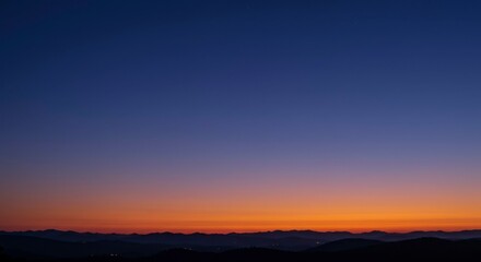 Fototapeta premium Blurry sunrise over misty mountains