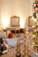 Ornate golden decorations and floral arrangements at an elegant event, creating a sense of luxury and beauty.