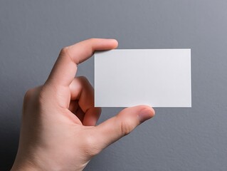 Hand Holding Blank Business Card Mockup Gray Background Perfect for Branding and Design Presentations