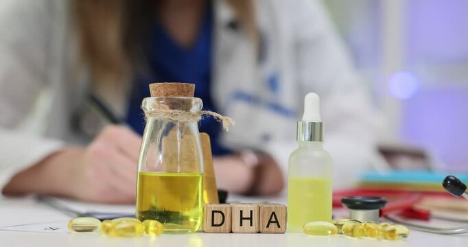 Doctor writes notes on clipboard near DHA omega 3 on cubes fatty acid supplement. Woman with medical prescription during consultation near stethoscope