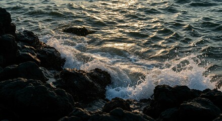 Ocean waves crashing on dark rocks