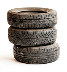 Three used tires stacked vertically, showing dark tread patterns and dirt