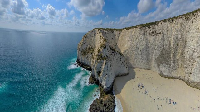 Aerial view of a beach, cliff above the water - 360 loop video