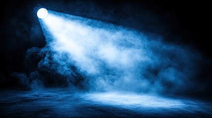 Fototapeta premium Blue spotlight illuminates smoky stage backdrop.
