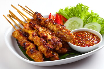 Pork satay with spicy sauce on white background, thai food