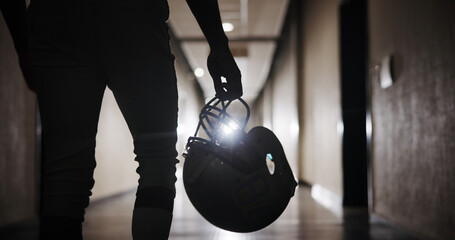 Helmet, football and hand of man in corridor for sports competition, stadium match and game. Fitness, pro league player and athlete with person in tunnel for training, tournament and contest © EinFrame25/peopleimages.com